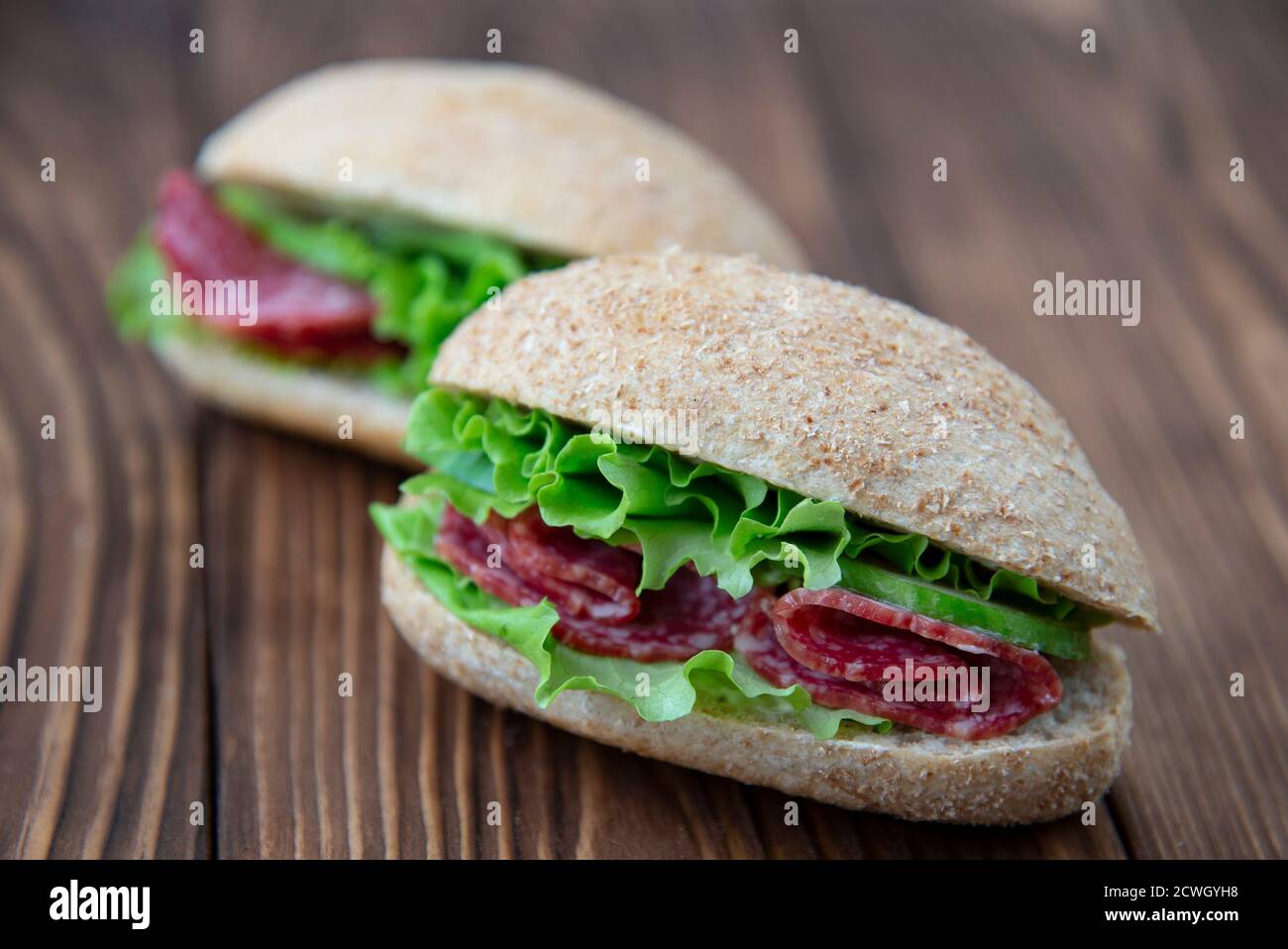 Fresh whole grain sandwiches with salami and lettuce Stock Photo - Alamy