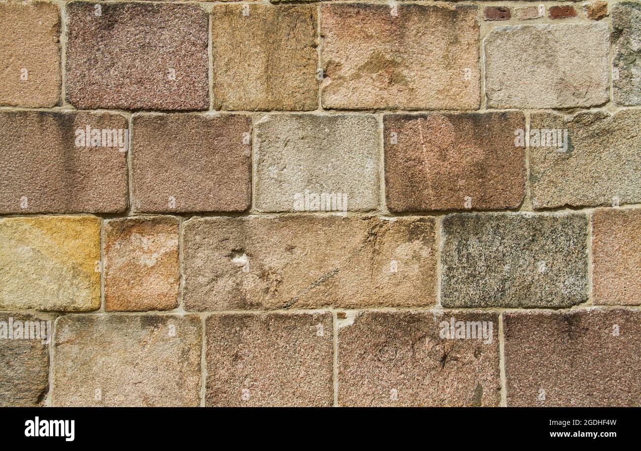 Medieval masonry, solid wall of rough granite blocks, background Stock ...