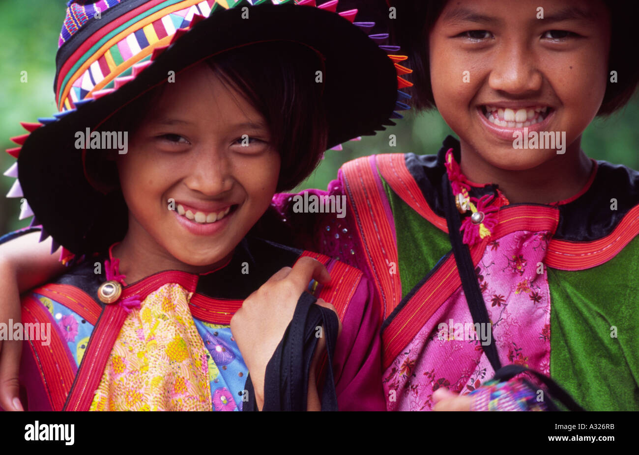 Close cropped portrait of two friendly smiling tribal Thai girls in ...