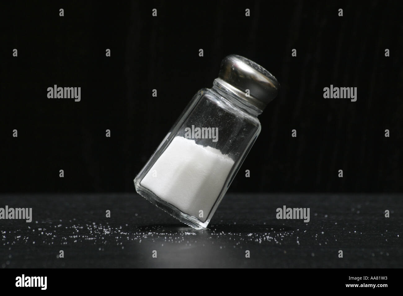 Salt shaker balancing on edge Stock Photo Alamy