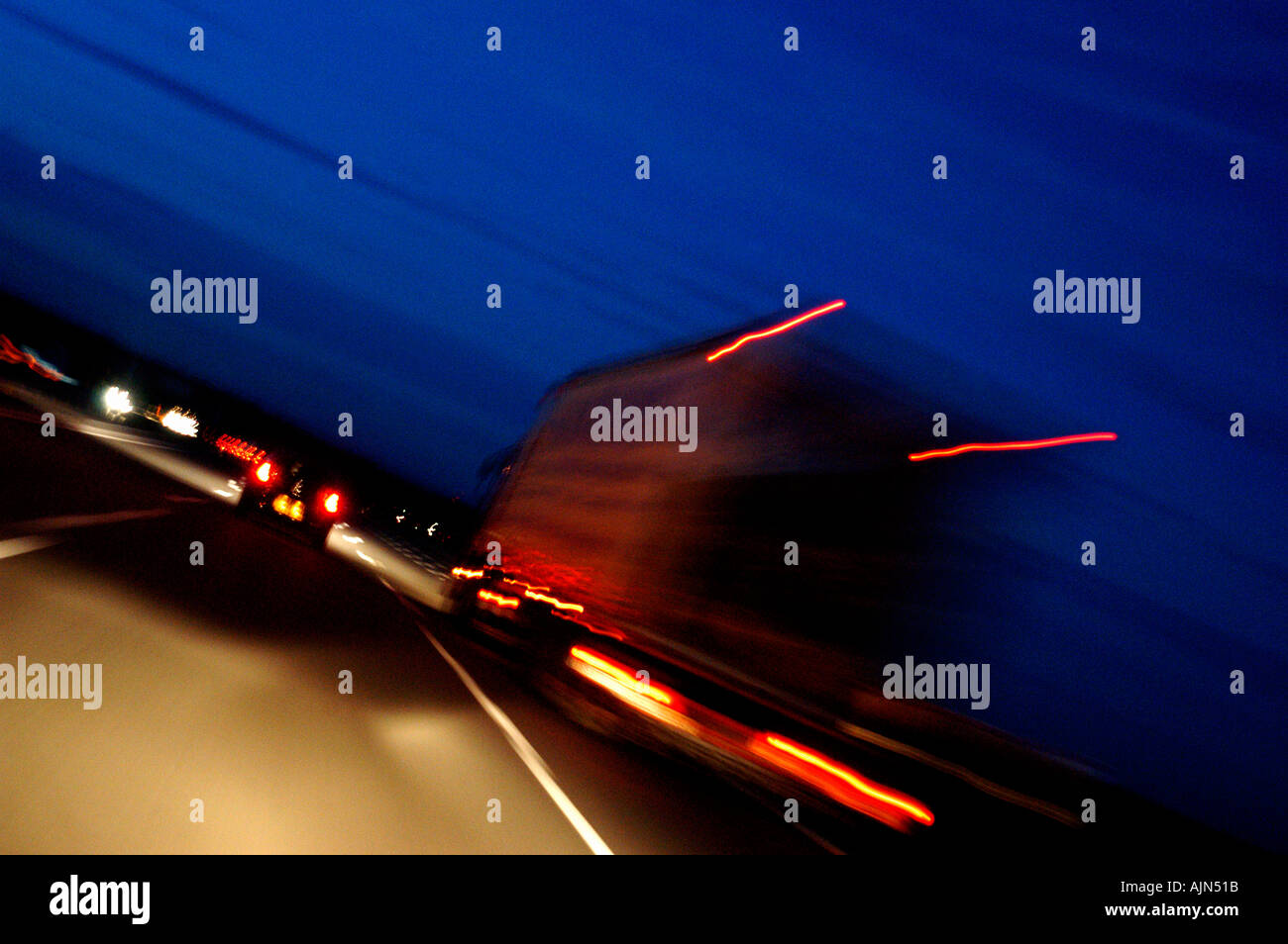 Delivery lorry speeds through the night as dusk arrives Stock Photo - Alamy