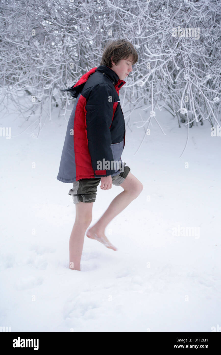 Young Boy Walking Barefoot Through Snow Stock Photo Alamy