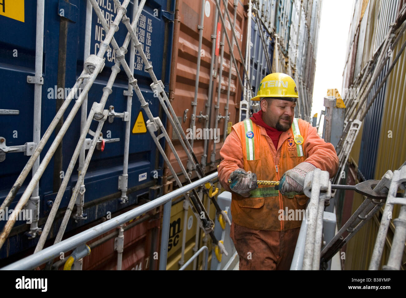 Longshoreman secures shipping containers on ship in the Port of Oakland