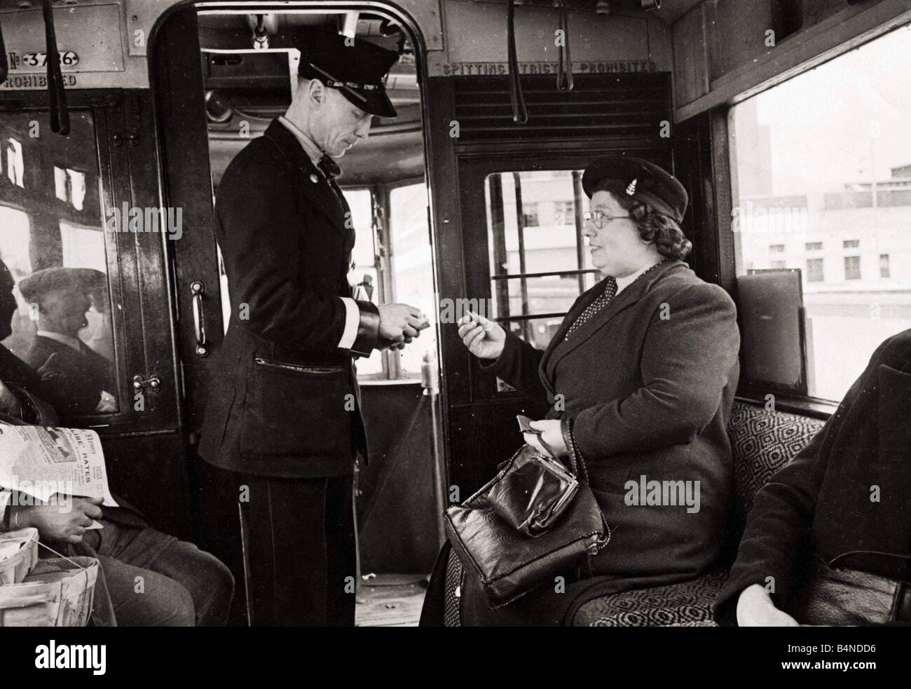 Bus Conductor collecting fares for passengers circa 1948 Stock Photo ...