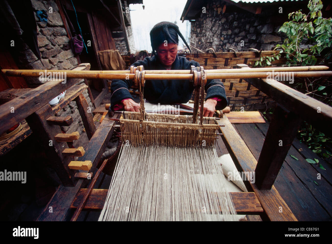Monpa tribal man weaving carpet on handloom ; Monpa tribe ; Tawang ...