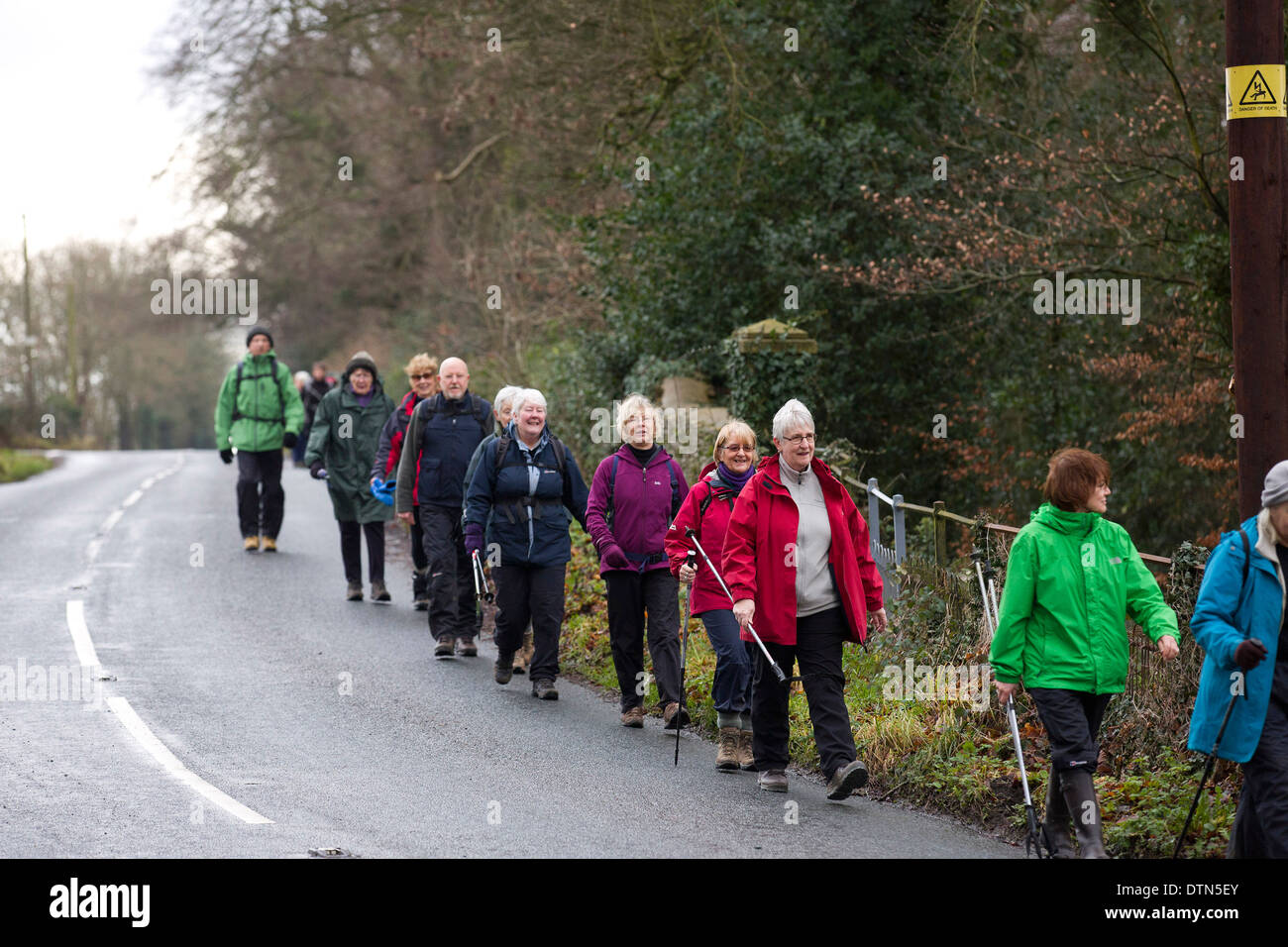 Uk Gloucestershire A Group Of Ramblers Walk Along The Side Of The Road Through Country Near 4667