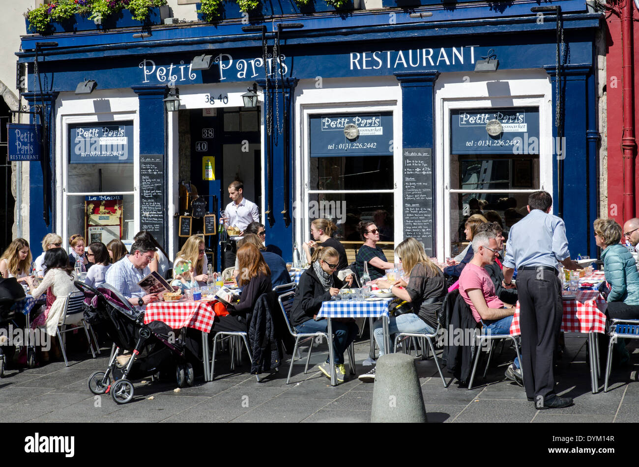 Diners eating outside the "Petit Paris" French restaurant in the