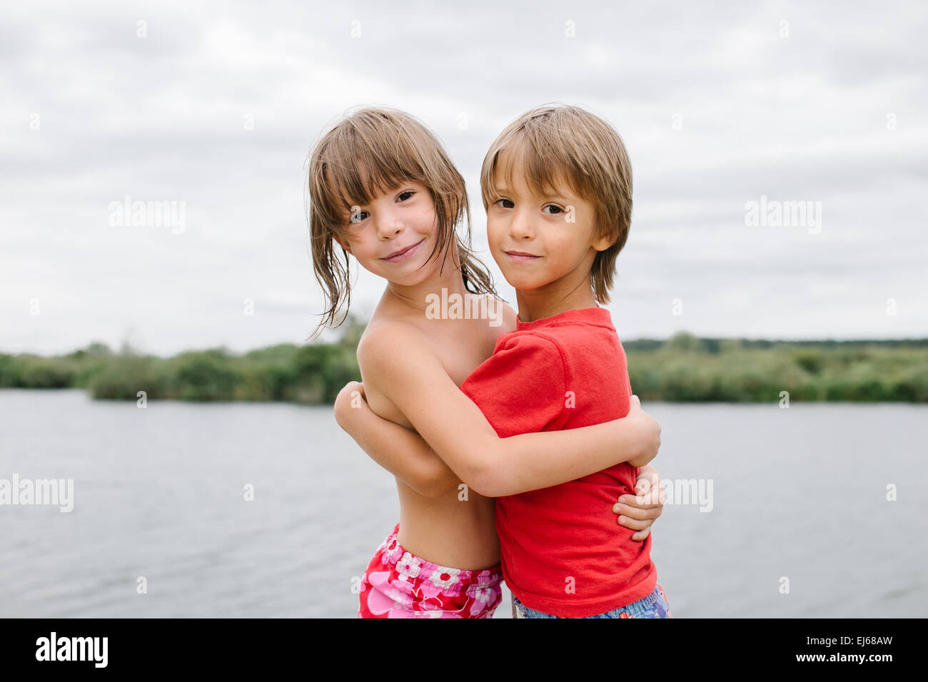 Cute Happy Fraternal Twins Enjoying Their Time At The Beach Brother And Sister Hugging Having