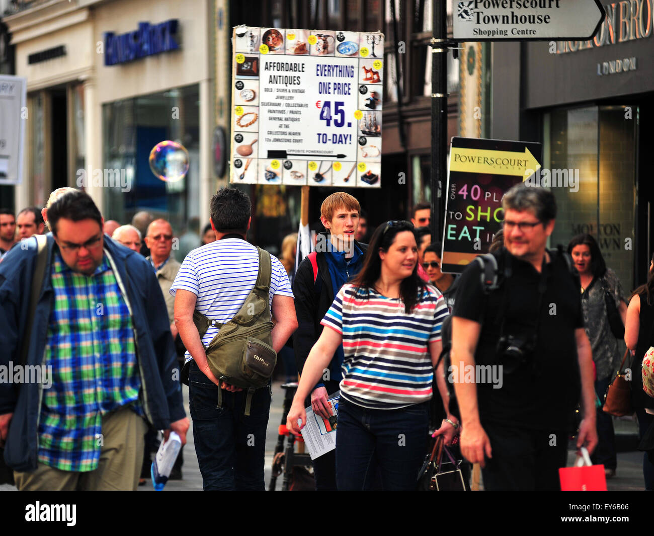 Pedestrians and shop promotion signs in the centre of Dublin in Ireland ...