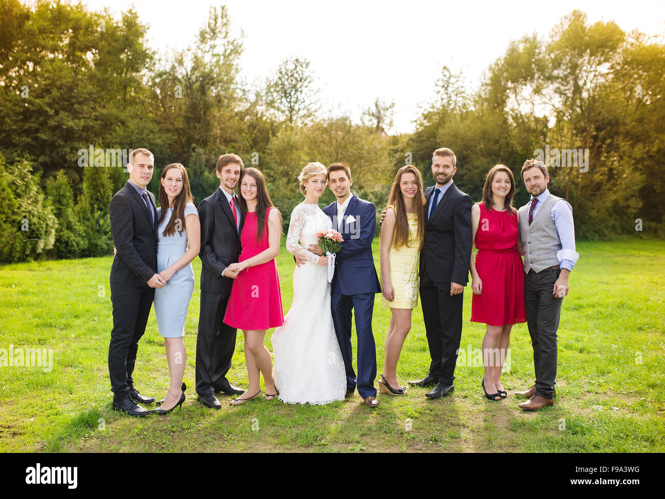 Full Length Portrait Of Newlywed Couple Posing With Bridesmaids And Groomsmen In Green Sunny 1103