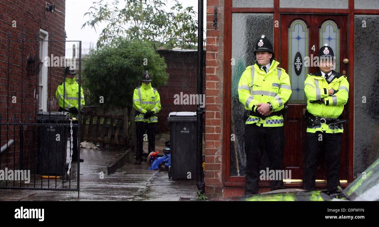 Greater Manchester Police Stand Guard Outside Two Of The Three Houses In The Cheetham Hill Area 