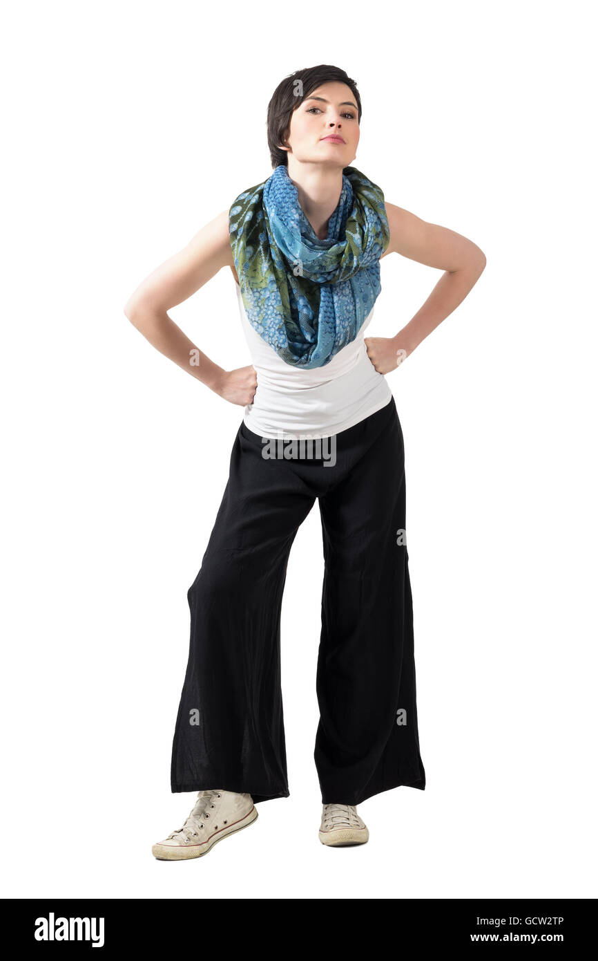 Short hair fashion model with shawl and wide trousers posing with arms ...