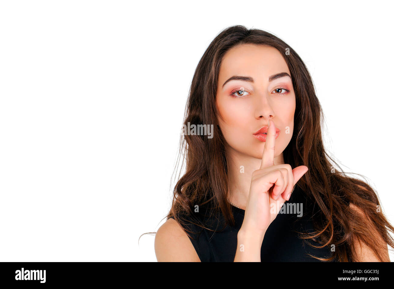 Young Beautiful Brunette Woman Has Put Forefinger To Lips As Sign Of