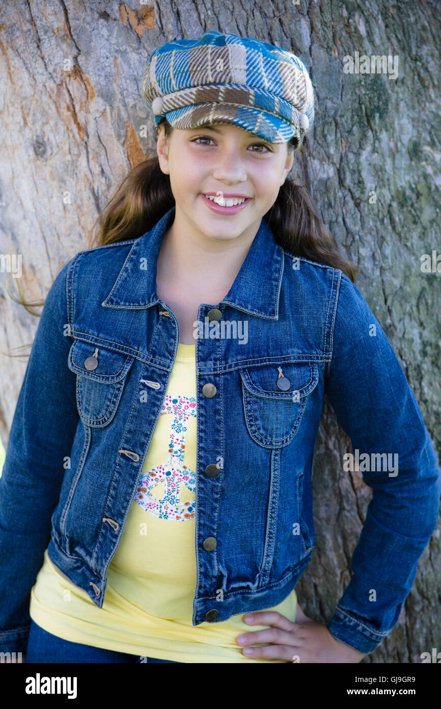 Tween Girl Leaning Against Tree In Park Stock Photo Alamy