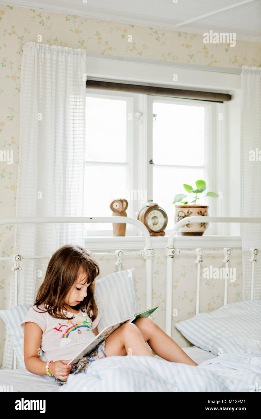 Girl Reading In Bed Stock Photo Alamy