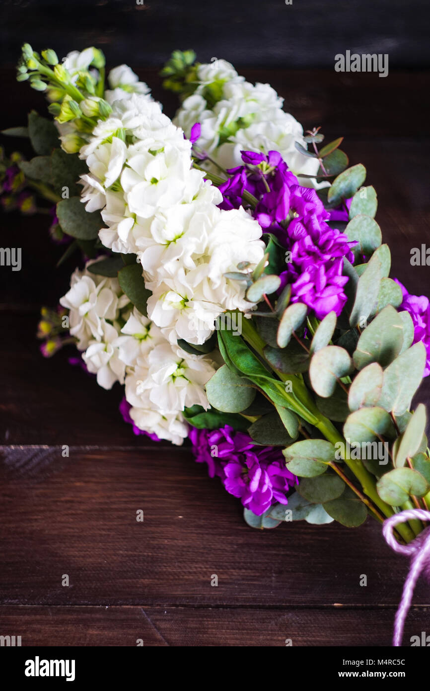 Beautiful bridal bouquet with fresh snap dragon flowers on wooden table ...