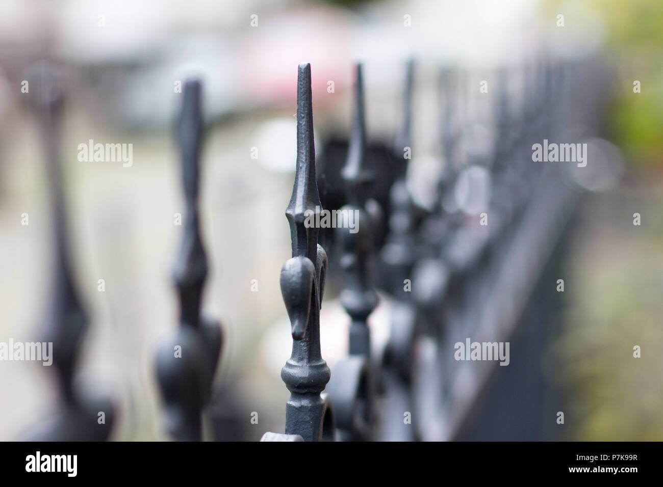 Metal fence, tips, detail, blurred writing Stock Photo - Alamy