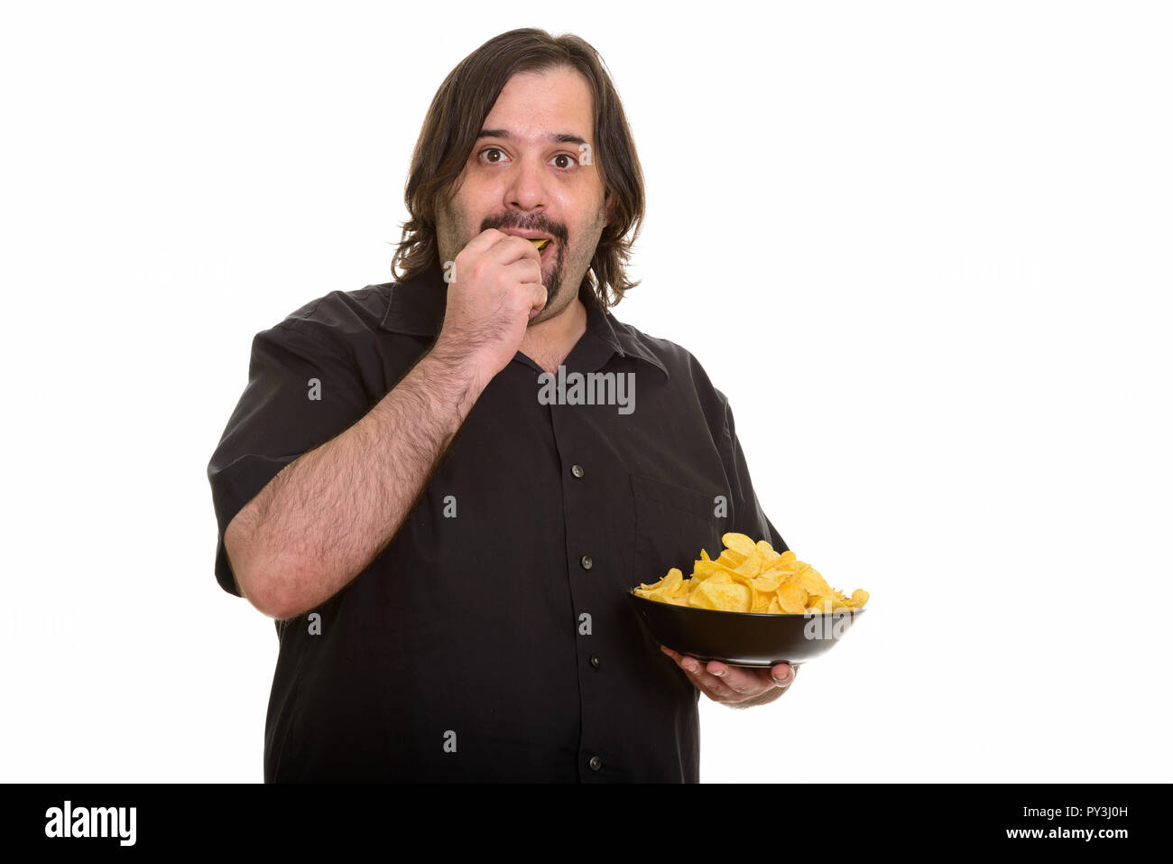 Fat Caucasian man eating and holding bowl of chips Stock Photo - Alamy