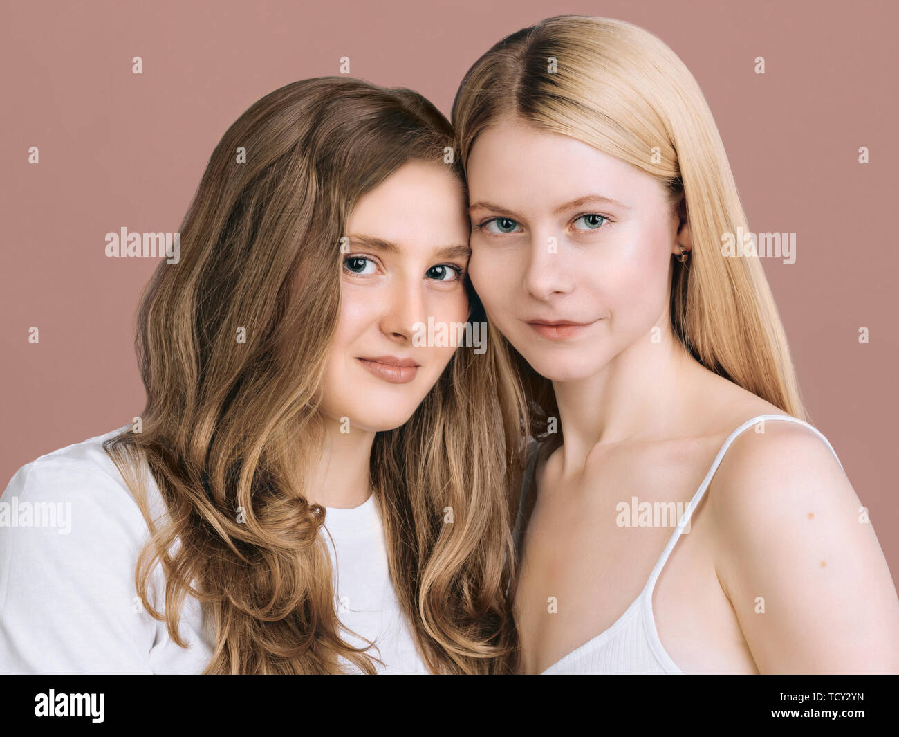 Two Best Friends Close Up Portrait Long Haired Blonde And Brunette Are Standing Next To Each 