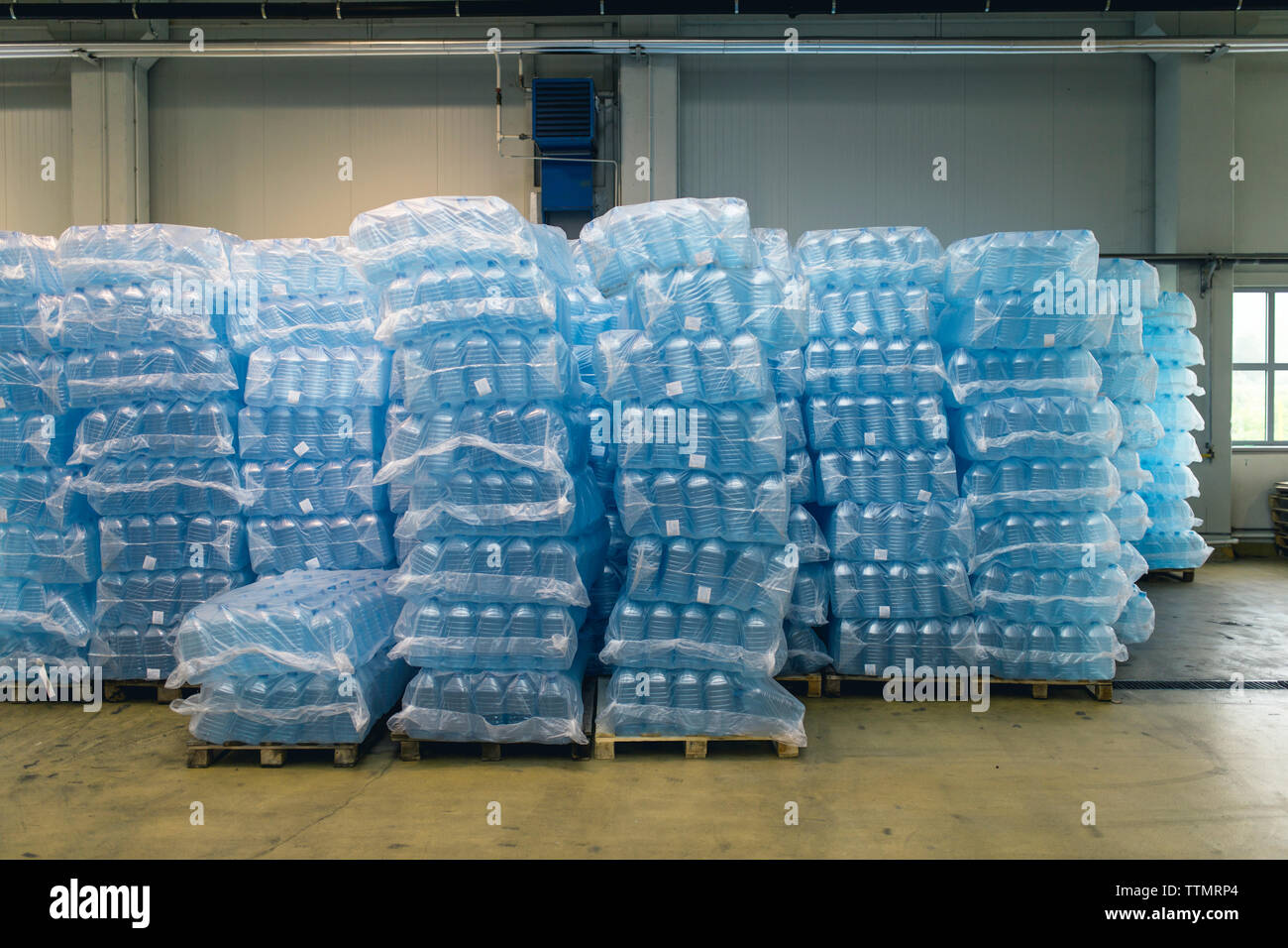 Pallets of water bottles in warehouse Stock Photo Alamy